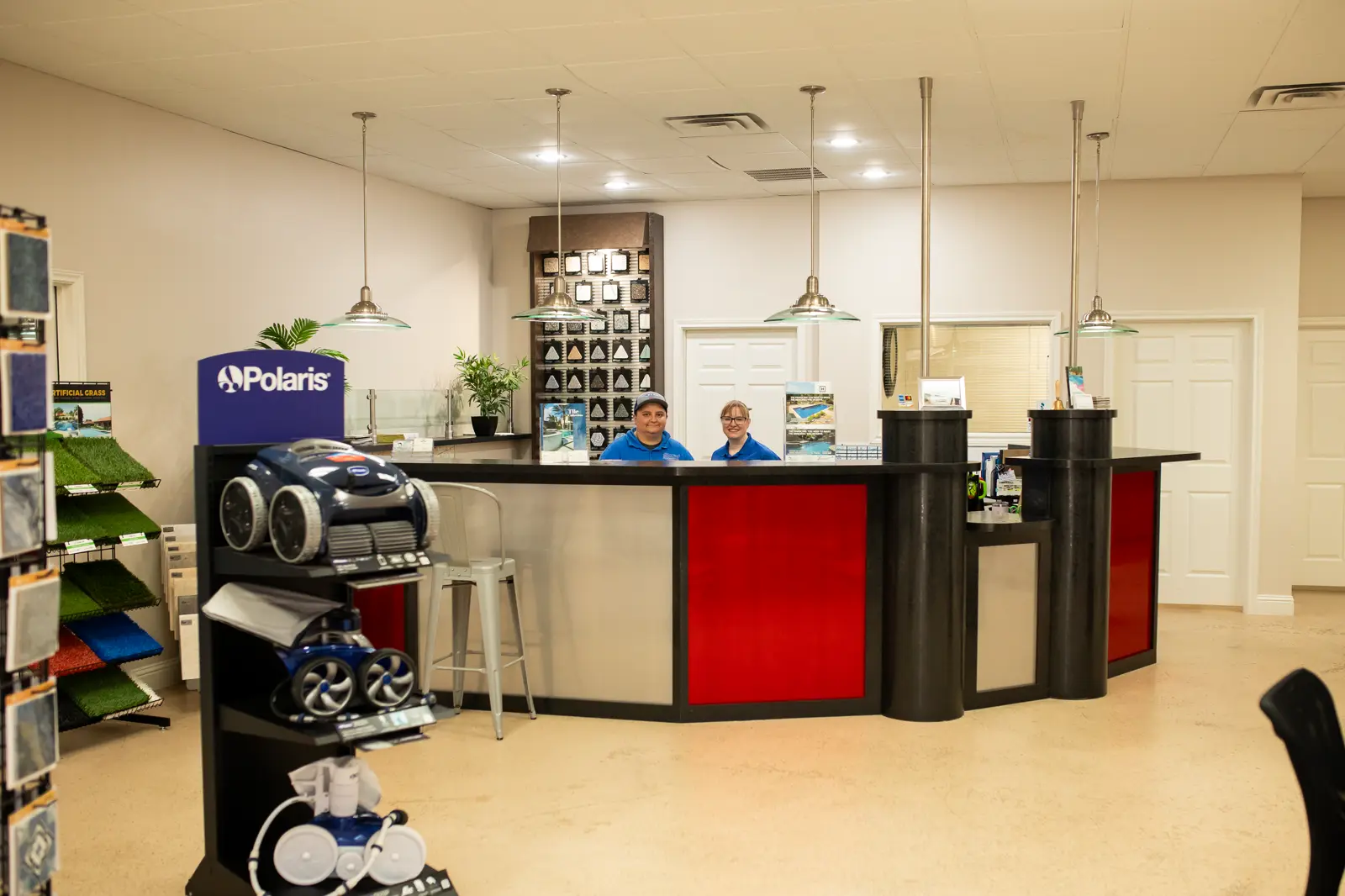 U.S. Pool Professionals team members at the showroom front desk in Rockwall