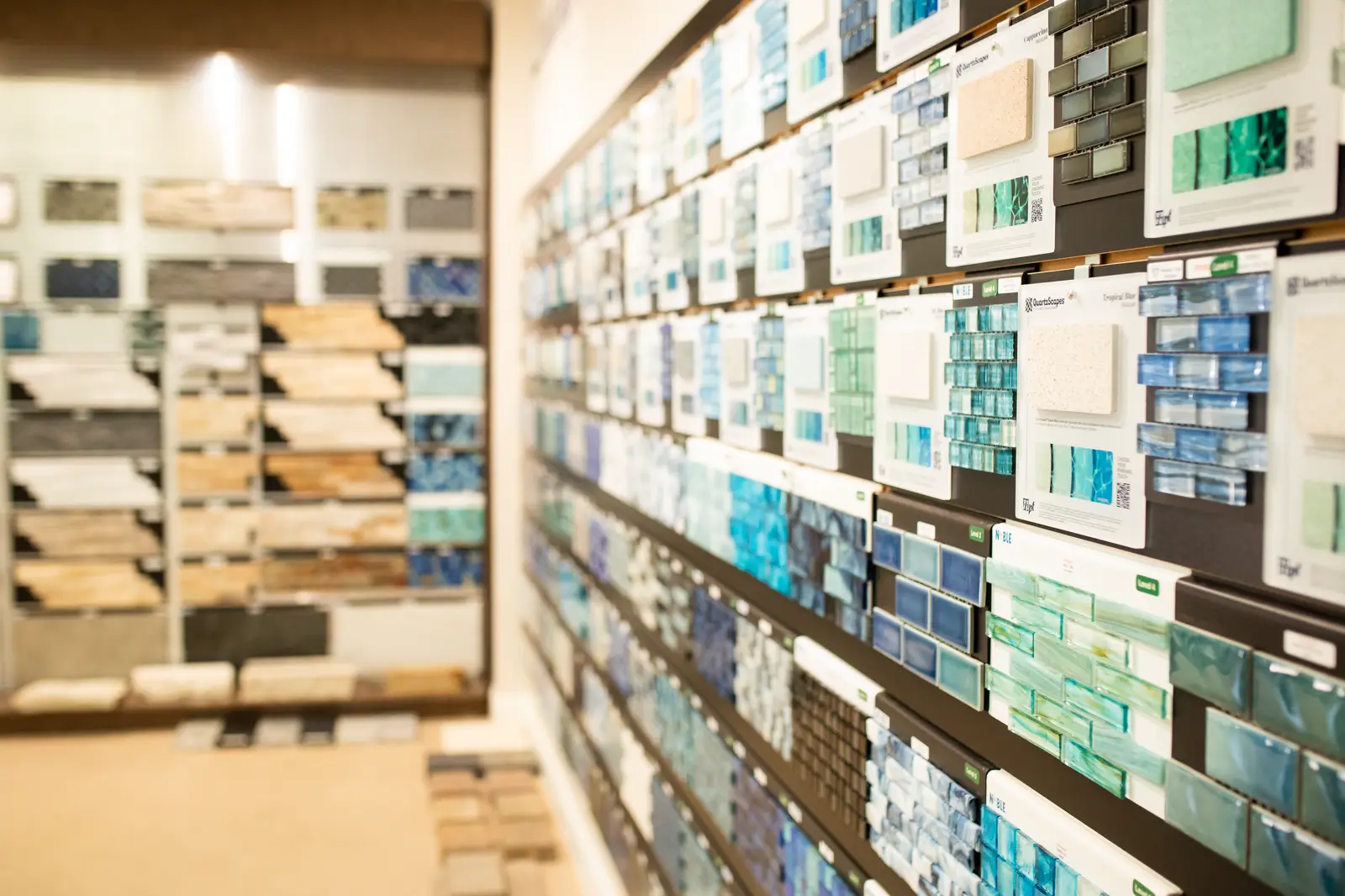 Wall of glass and mosaic pool tile samples in the Rockwall showroom