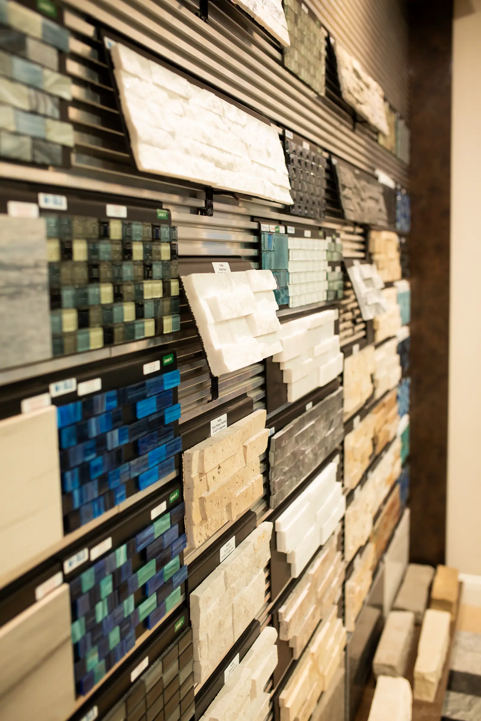 Close-up of ledgestone and mosaic tile textures on the showroom display wall