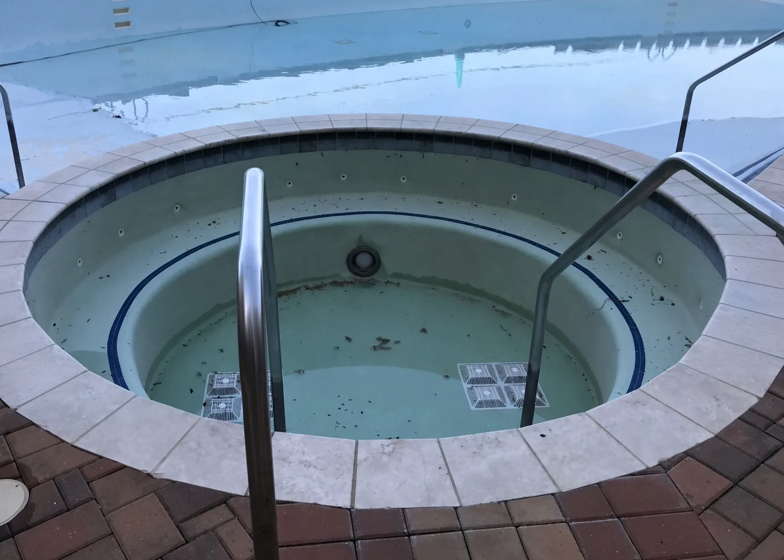 Apartment community pool before and after resurfacing
