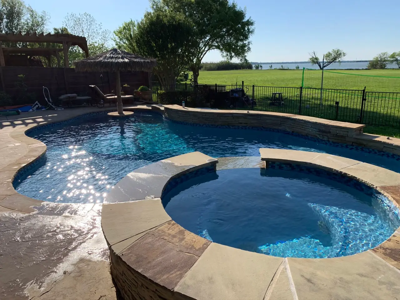 Rockwall, Texas lakefront home with a pool overlooking Lake Ray Hubbard at sunset